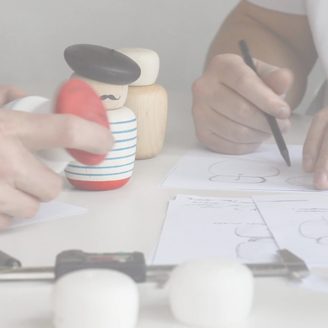 Product development image with designers sketching and reviewing materials